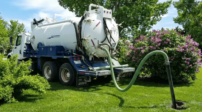 Professional vacuum truck performing residential drainage and septic maintenance in ,